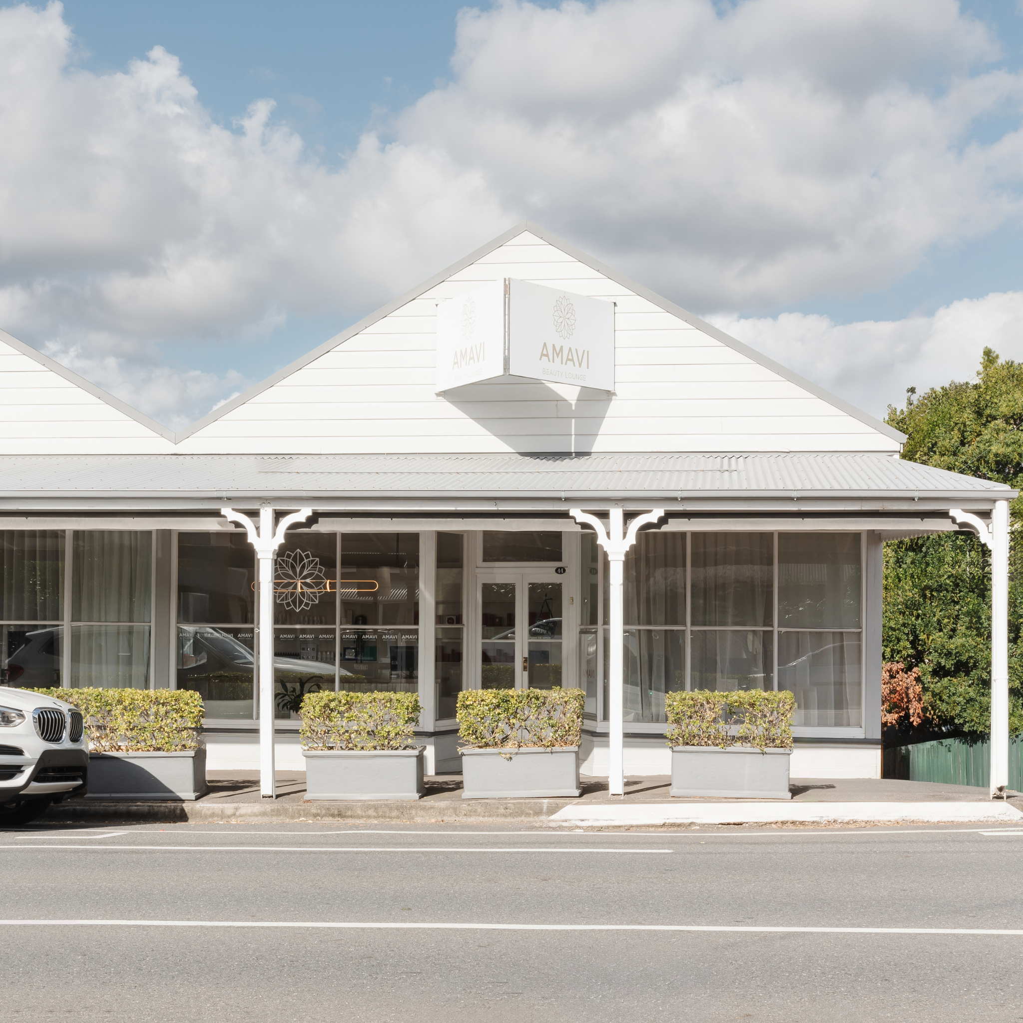 Exterior of Amavi Beauty Lounge in Red Hill, Brisbane, featuring white heritage-style salon front and modern signage.