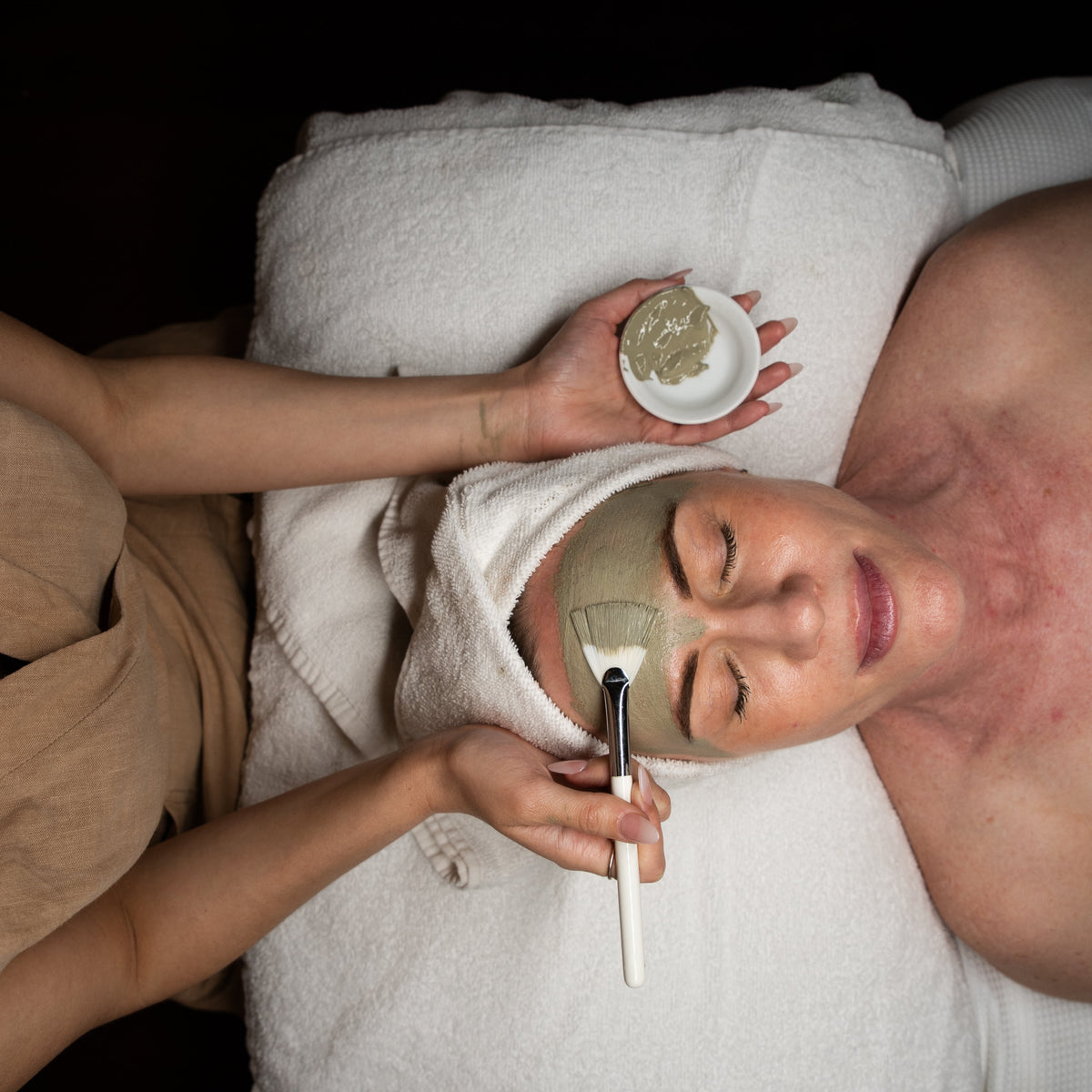 A clay treatment mask applied with a brush during a customised facial at Amavi Beauty Lounge, Brisbane
