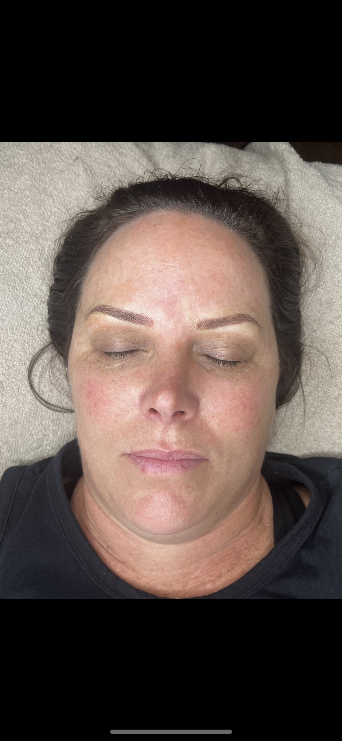 The same client after microblading, with shaped, natural-looking brows framing the eyes