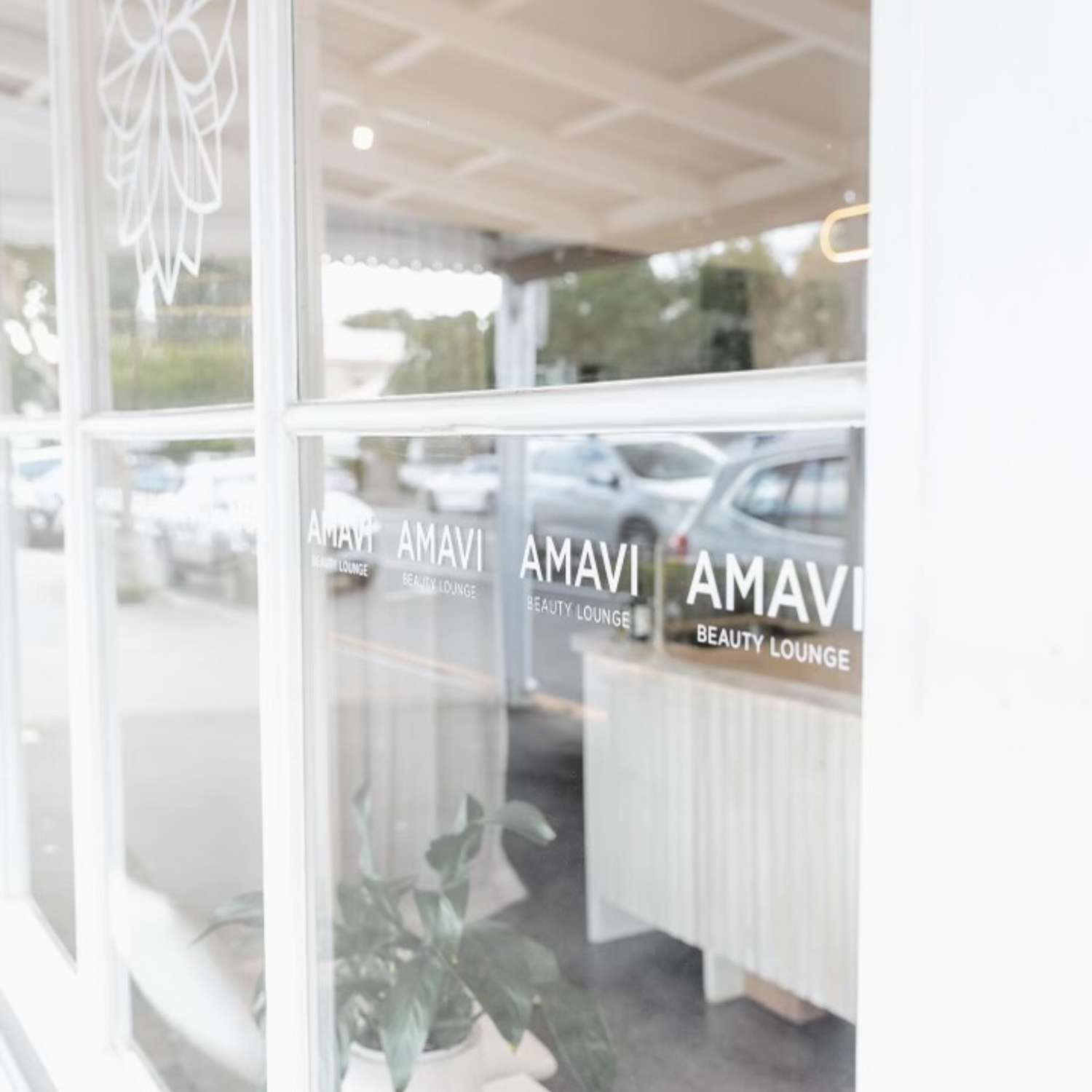 Branded window signage at Amavi Beauty Lounge in Red Hill, Brisbane, showcasing the salon’s minimalist aesthetic and welcoming entry.