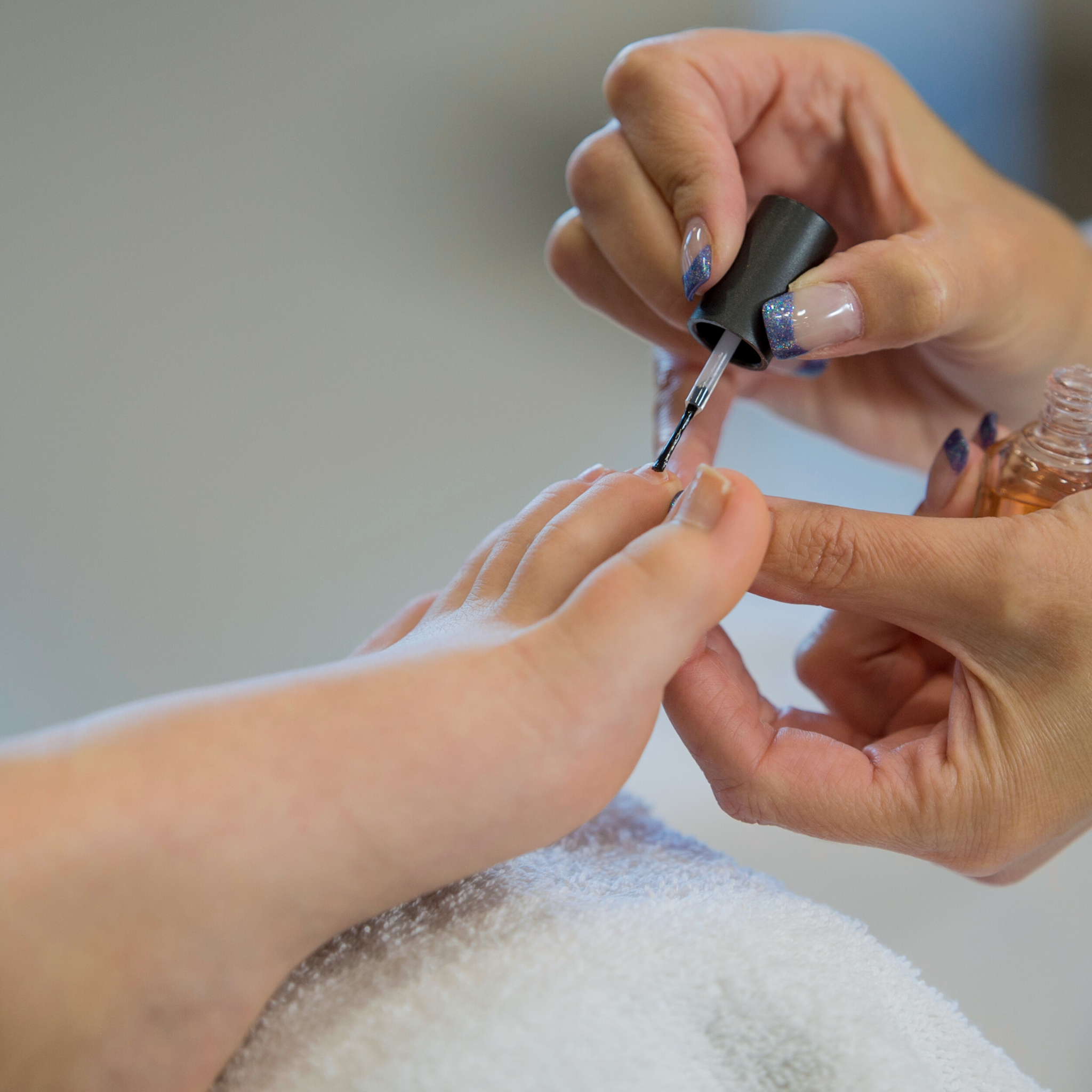 Close-up of professional pedicure with nail polish application at Amavi Beauty Lounge in Brisbane